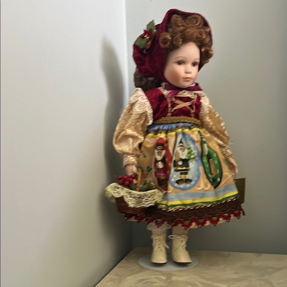 Elegant Red and Gold Doll with Basket